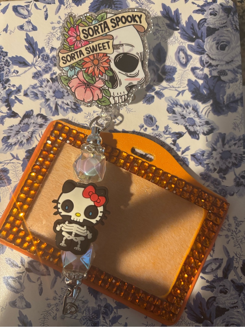 Hello Kitty Skeleton Badge Reel with Orange Bejeweled Frame